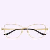 The Cartier Optical CT0523O-001 55 sunglasses feature gold rectangular thin metal frames, clear lenses, black temple arms, and adjustable nose pads for a luxurious eyewear look on a light purple background.