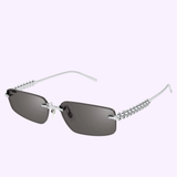 Cartier Sunglasses CT0544S-003 58 feature rectangular dark lenses, slim silver arms, and a zigzag metal design along the temples—luxury eyewear from Cartier Sunglasses displayed on a light purple background.