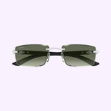 Cartier Sunglasses CT0582S-005 56 Men feature rectangular green lenses, a silver metal frame, and black arms—ideal luxury eyewear for men—displayed on a light purple background.