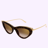 Cartier Sunglasses CT0596S-002 55 Women feature cat-eye tortoiseshell frames with gold accents and slim gold arms, embodying women's luxury eyewear style. Displayed against a light purple background.
