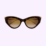 Cartier Sunglasses CT0596S-002 55 Women feature cat-eye tortoiseshell frames with gold accents and slim gold arms, embodying women's luxury eyewear style. Displayed against a light purple background.