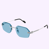 Cartier Sunglasses CT0616S-005 54 feature geometric blue-tinted lenses, silver metal arms, and black tips, set against a light purple background—a luxurious statement from Cartier Sunglasses.