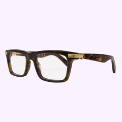The Cartier Optical CT0420O-006 56 features rectangular tortoiseshell men's frames with thick detailing and gold-accented hinges, displayed on a light purple background—ideal for those seeking luxury eyewear.