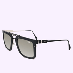 Discover the Cazal 648 002 56 Unisex Sunglasses by Cazal Sunglasses, featuring a stylish black and silver square design with gradient lenses, accented by a metal bridge and slender arms. Inspired by the iconic Cazal 648 style, these sunglasses showcase the Cartier logo on both the lenses and temples. Set against a light lavender background.