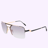 Rectangular unisex sunglasses featuring a gold metal frame, black arms, and gradient gray lenses are showcased on a light purple background. The Cazal 9102 001 61 Unisex Sunglasses by Cazal Sunglasses offer bold style and iconic design elements for a standout look.