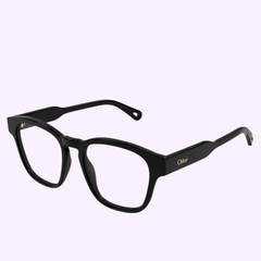 The Chloe CH0161O-001 51 Optical Frame for women from Chloe Sunglasses showcases black rectangular thick frames with clear lenses and the signature Chloé logo in gold on the temples, elegantly displayed on a light purple background—a refined option in luxury eyewear for those seeking sophisticated optical frames.