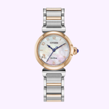 The Citizen Watches EM1136-87D Citizen L Mae women's watch by Citizen Watches features a round mother-of-pearl face, gold-tone bezel, silver and gold-tone bracelet, and blue-tipped crown, displayed on a light purple background for sustainable luxury.