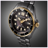 The Citizen Watches Promaster Dive LIGHT in BLACK BN0264-53E features Eco-Drive, a black and gold bezel, textured black dial, luminous markers, and a stainless steel bracelet, displayed angled on a gray gradient background.
