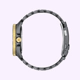 Side view of the Citizen Watches Promaster Dive LIGHT in BLACK BN0264-53E, a limited edition by Citizen Watches with a gold crown and bezel, black and gold case, and black metal bracelet against a light purple background.