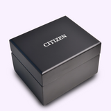 A closed black box with CITIZEN in white letters on the lid rests on a light surface, hinting at the exclusive Citizen Watches Series8 890 City Lights NB6060-58H inside.