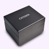 A black rectangular box with CITIZEN in white on the lid, likely containing a Citizen Watches Series8 NB6084-50A, rests elegantly on a light background.
