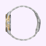 A side view of the Citizen Watches Series8 NB6084-50A shows its silver stainless steel case, gold accents, and two-tone metal band against a light purple background.