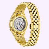 Back view of the yellow gold-tone Citizen Watches TSUYOSA 60 37mm NK0032-56A watch, showcasing its mechanical movement through a clear case back and its link bracelet.