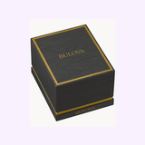 A black Bulova Watches box with gold accents and logo on the lid and base, ideal for presenting the Bulova Watch Futuro 97D115 Men, shown against a light background.