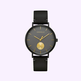 The Bulova 44A119 Min Max Caravelle watch by Caravelle Watches By Bulova features a black leather strap, gray face, gold hour markers and hands, a gold subdial, and the brand name elegantly displayed near the top.