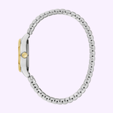 A side view of the Bulova 45L185 Traditional Caravelle women’s watch by Caravelle Watches By Bulova, featuring a two-tone stainless steel strap with gold accents, set against a light purple background.