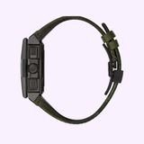 A side view of the Bulova 98B355 Precisionist men's watch by Bulova Watches, featuring a dark rectangular case, black crown, and olive green textured leather strap, set against a light purple background.