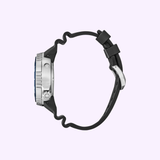 A side view of the Citizen Watches Promaster Dive E365 BN1025-08L with a silver case, black textured bezel, and wavy black rubber strap is shown against a light purple background.