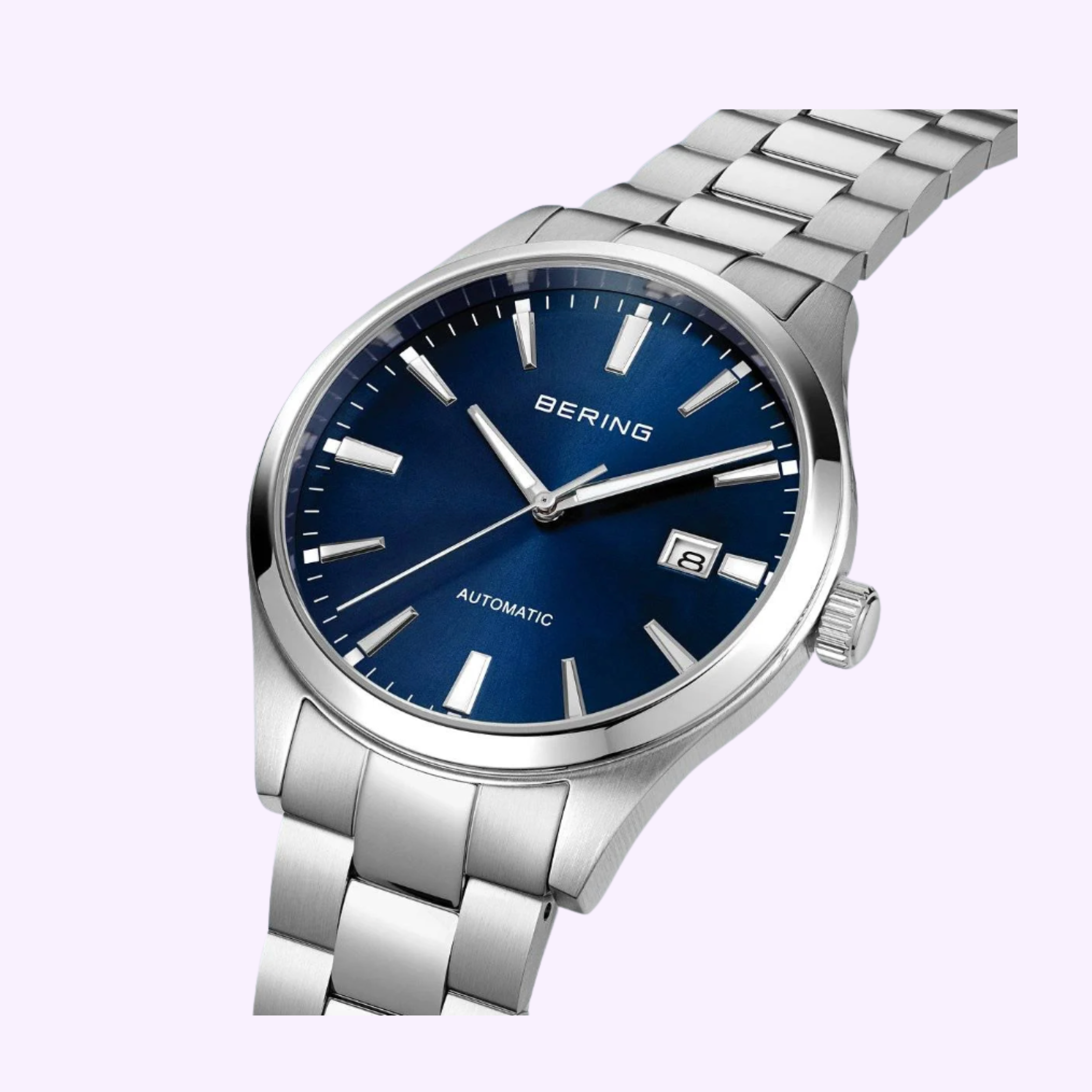 The Bering Watches Classic 19842-707 is a women’s wristwatch with a silver metal band, blue dial, silver hour markers and hands, and a date window at 3 o’clock—showcasing Scandinavian minimalism against a light background.