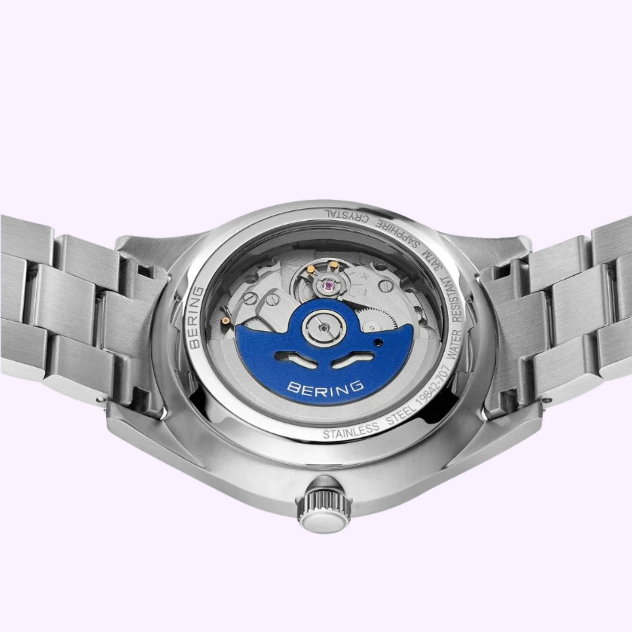 Close-up of the Bering Watches Classic 19842-707's stainless steel back, highlighting its transparent case and visible automatic movement with a striking blue rotor—showcasing Bering Watches' Scandinavian minimalism.