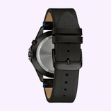 Back view of Bulova 45C118 Classic Caravelle Men’s Watch by Caravelle Watches By Bulova, featuring a black leather strap, black buckle engraved with CARAVELLE, metal case, and quartz movement on a light purple background.
