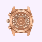 The Tissot Watches PR516 Quartz Chronograph T1494173305100 features a rose gold case back with the Tissot logo, laurel wreath, sapphire crystal details, stainless steel markings, 100 bar water resistance, and model information.