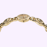 The Versace Watches VE3C00222 Stud Icon Bracelet Watch features a gold round face and a chain of embossed medallions, shown from the side against a light purple background. This elegant Swiss Made jewelry piece is perfect for women.