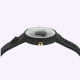 Side view of the Versace Watches VE6G00223 Medusa Pop Silicone Women's Watch showing a raised Medusa head on the face, gold crown, and black embossed band. Swiss Made quartz movement. Light purple background.