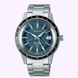 A Seiko Watches Presage Style60′s SSK009 with automatic movement, featuring a blue dial, silver hour markers, date window at 3 o’clock, and a stainless steel bracelet, is shown on a light lavender background.