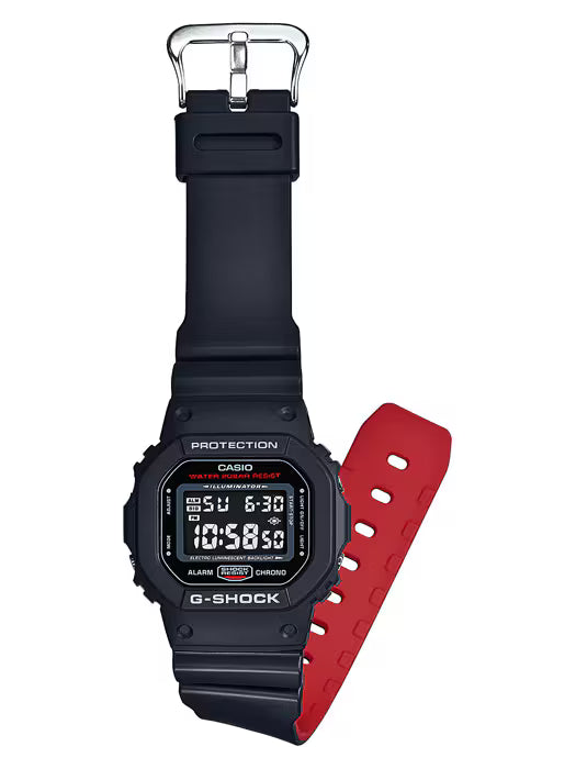 The CASIO G Shock Watch 5600 SERIES DW5600HR-1 by G-Shock Watches has a durable design with a black face, black upper strap, red lower strap, and digital display showing time and date.