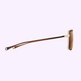 The Dita DLS422-A-01 Lancier Unisex Sunglasses by Dita Sunglasses are displayed from a side angle, highlighting one brown arm and the beige and brown frame set against a light purple background.