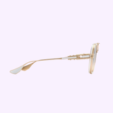 Side view of Dita Sunglasses DTS460-A-03 GRAND-DECADE Unisex with a gold frame and modern design, featuring the Dita Sunglasses and LEXOR MIAMI logos on a light grey background.