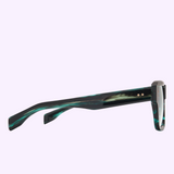 Side view of the Dita Sunglasses ELIUX DTS751-A-02, showcasing thick, green marbled Japanese acetate frames and straight arms from Dita Sunglasses, set against a light purple background.