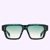 The Dita Sunglasses ELIUX DTS751-A-02 by Dita Sunglasses feature green and black marbled square frames, expertly crafted from premium Japanese acetate with gradient lenses, showcased from the front against a light purple background—a striking expression of luxury eyewear.