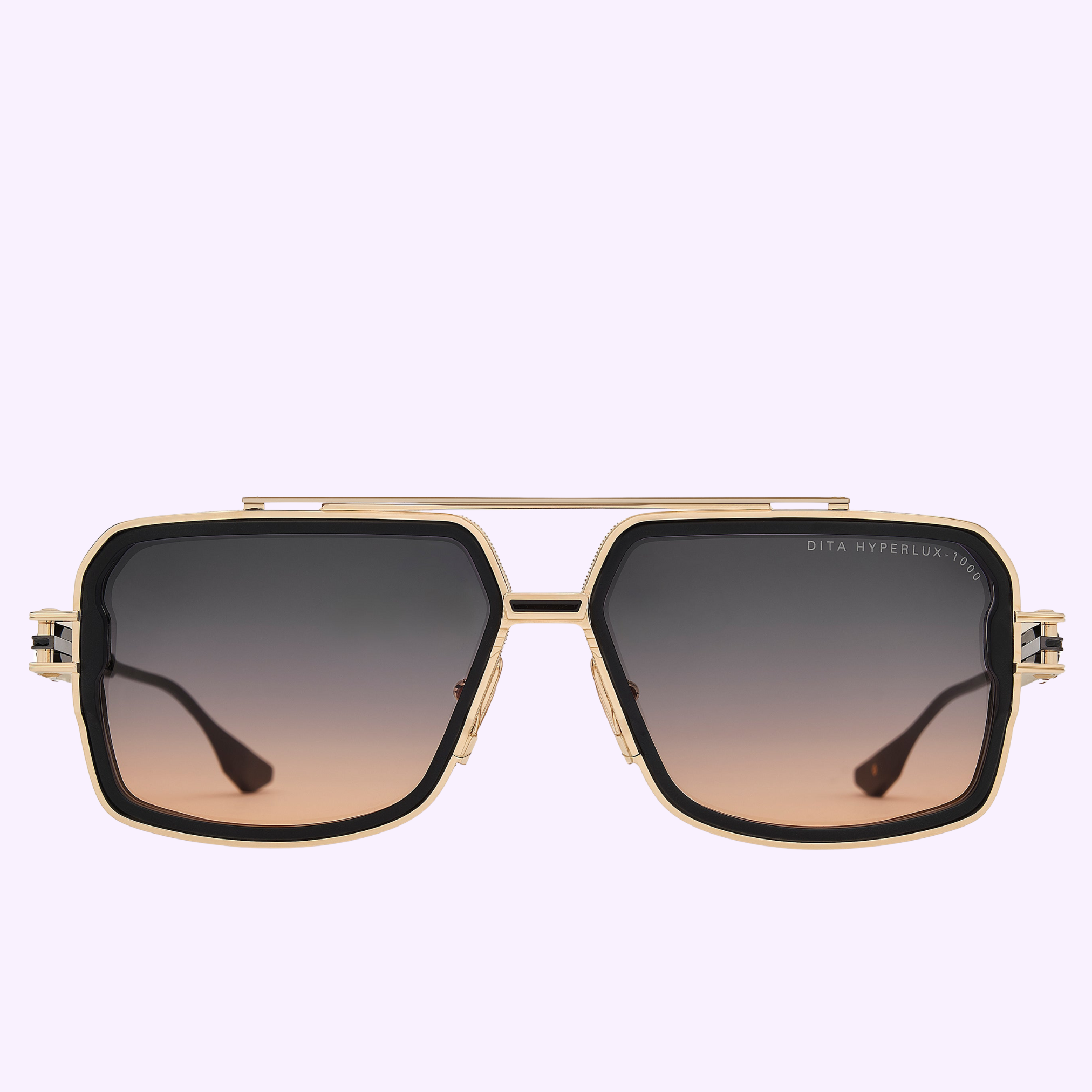 Dita Sunglasses HYPERLUX-1000 DTS470-A-02: gold-rimmed, geometric frames with Japanese titanium, dark gradient UVA/UVB lenses, straight top bar, and black accents, displayed on pale lavender. Right lens inscribed with DITA HYPERFLUX 21012.