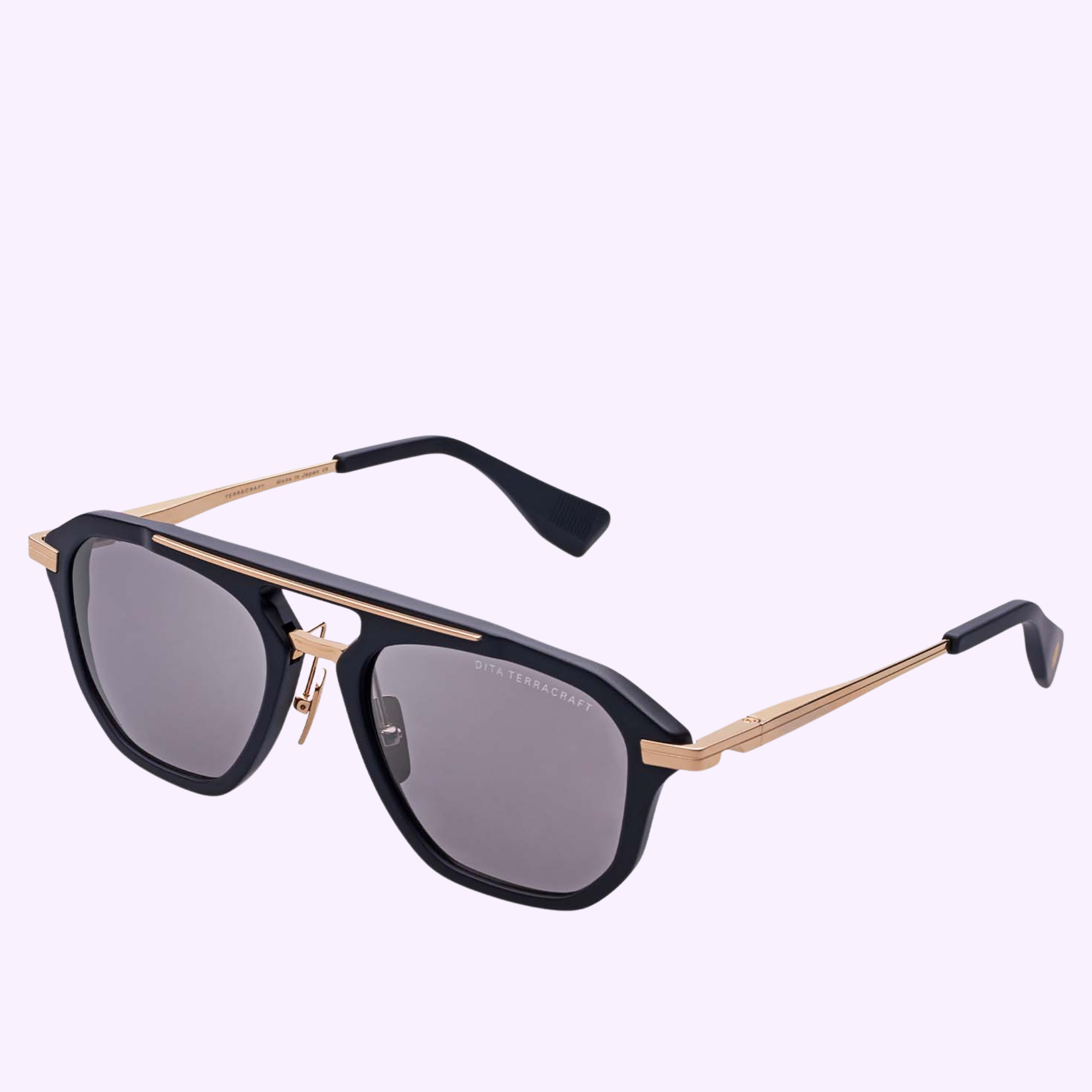 The Dita Sunglasses TERRACRAFT DTS416-A-01 by Dita Sunglasses feature a geometric navigator frame in black and gold with dark lenses and slim gold arms, shown against a light purple background.