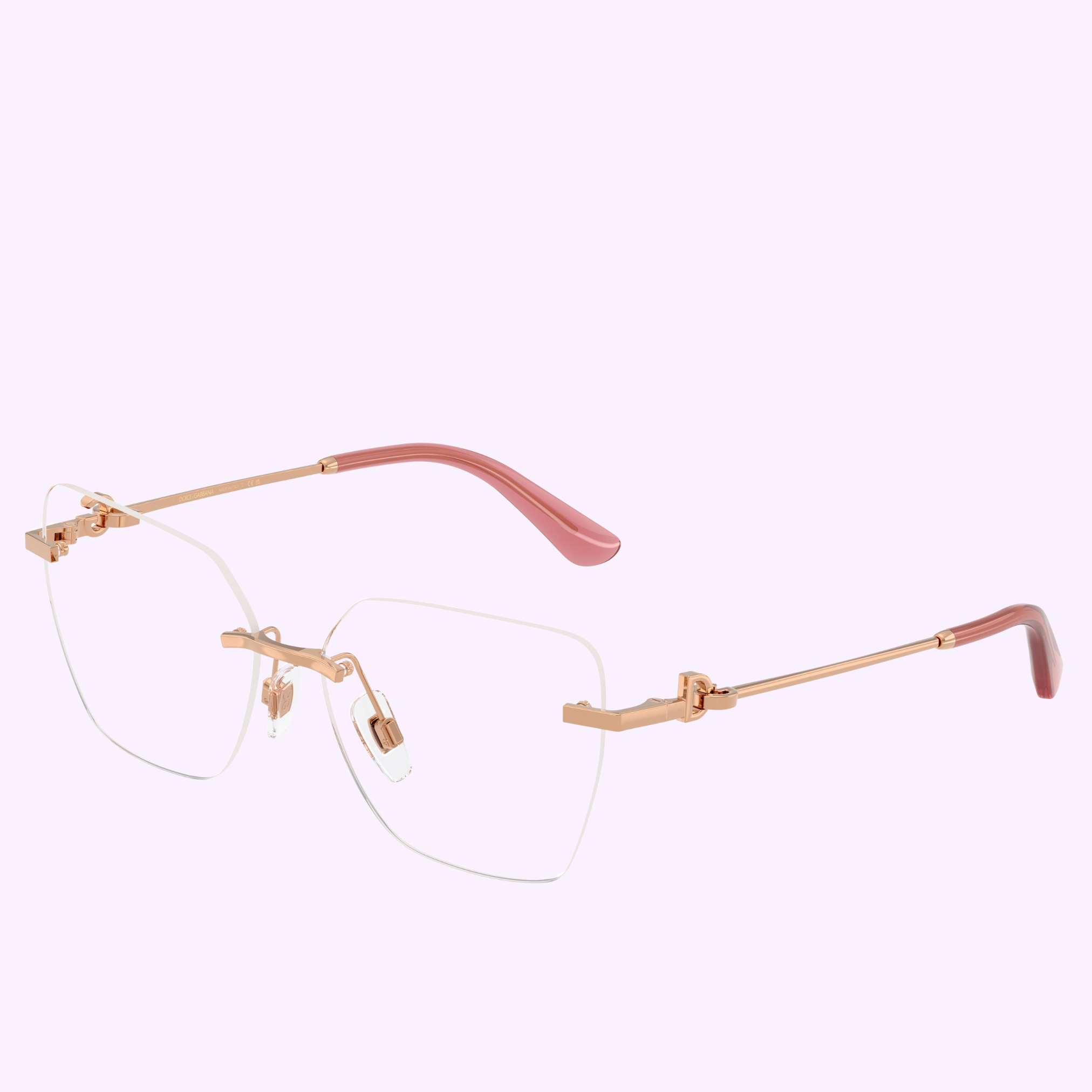 Dolce & Gabbana Optical Frames 0DG1363 1298 56 feature a rimless, geometric design with gold metal temples and pink tips. Displayed on a light purple background. Clear lenses, 100% authentic from an authorized Miami Dolce&Gabbana Sunglasses dealer.