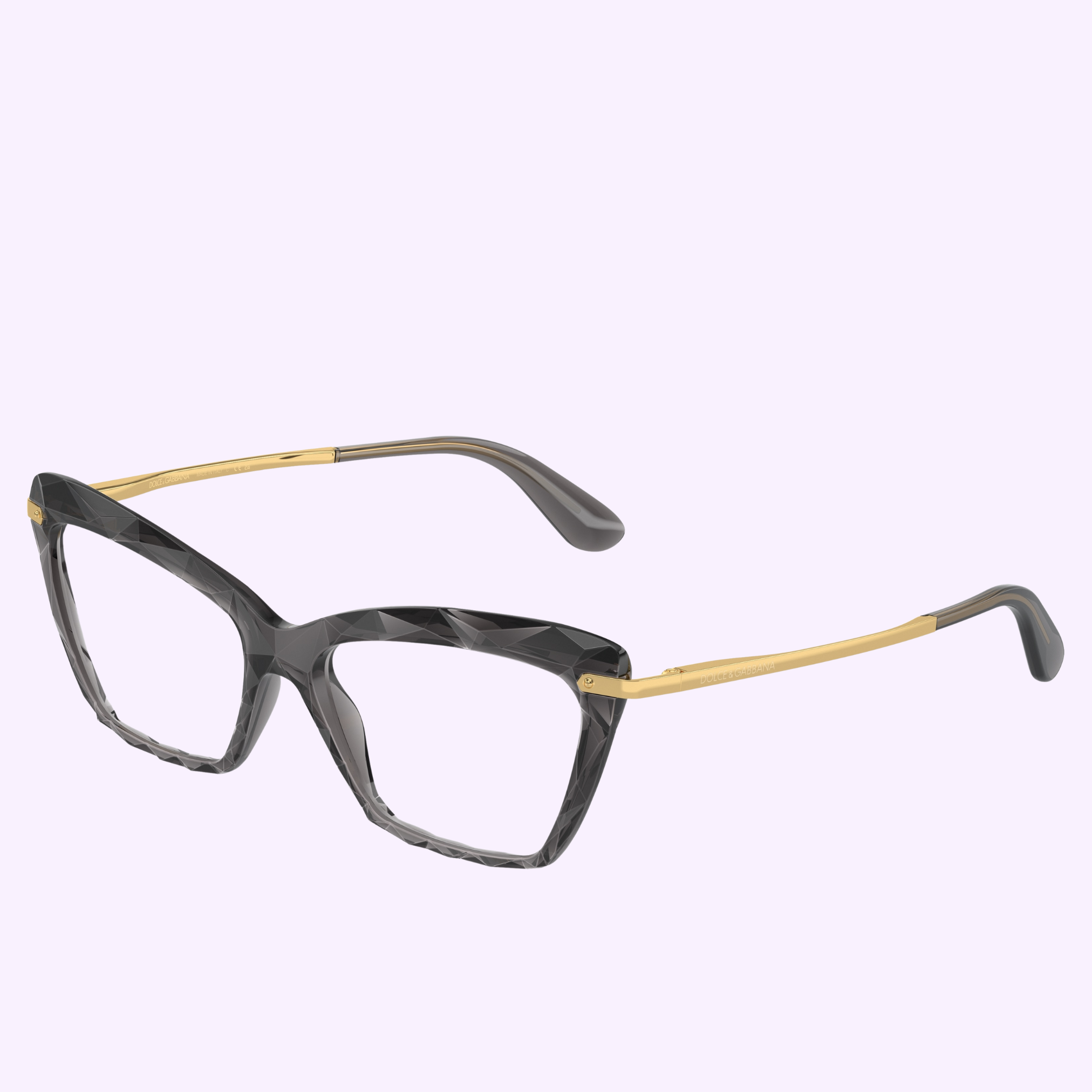 Discover the striking Dolce&Gabbana Optical Frames 0DG5025 504 53—black cat-eye glasses with faceted frames and gold metal temples, shown on a light purple background, from an authorized Miami dealer.