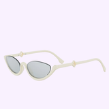 The Fendi Sunglasses FE40178U 5325C feature a cream cat-eye frame, dark tinted lenses, and FF Diamond accents at the hinges, all displayed on a light purple background.