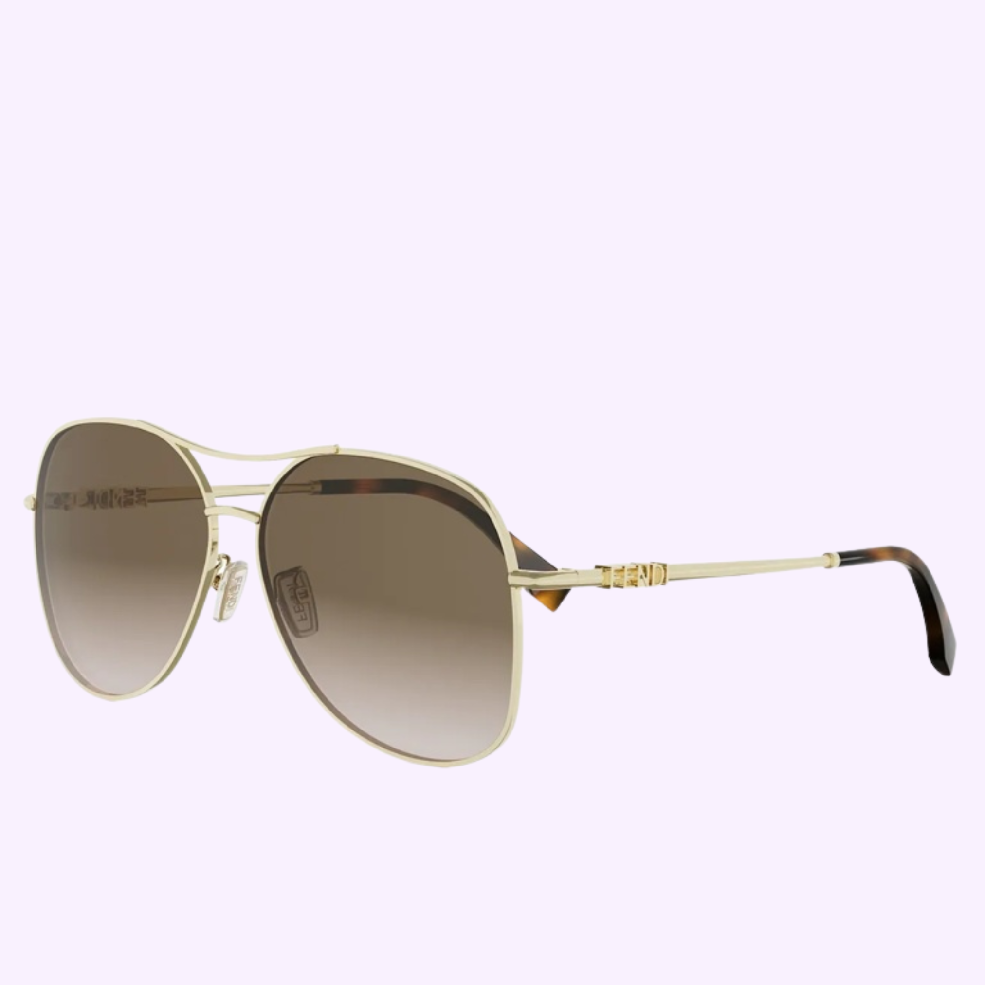 Fendi Sunglasses FE40200U 6130F WOMAN feature an aviator style with gold frames, brown gradient lenses, a double bridge, and thin metal arms with decorative detailing near the hinges, displayed on a light purple background.