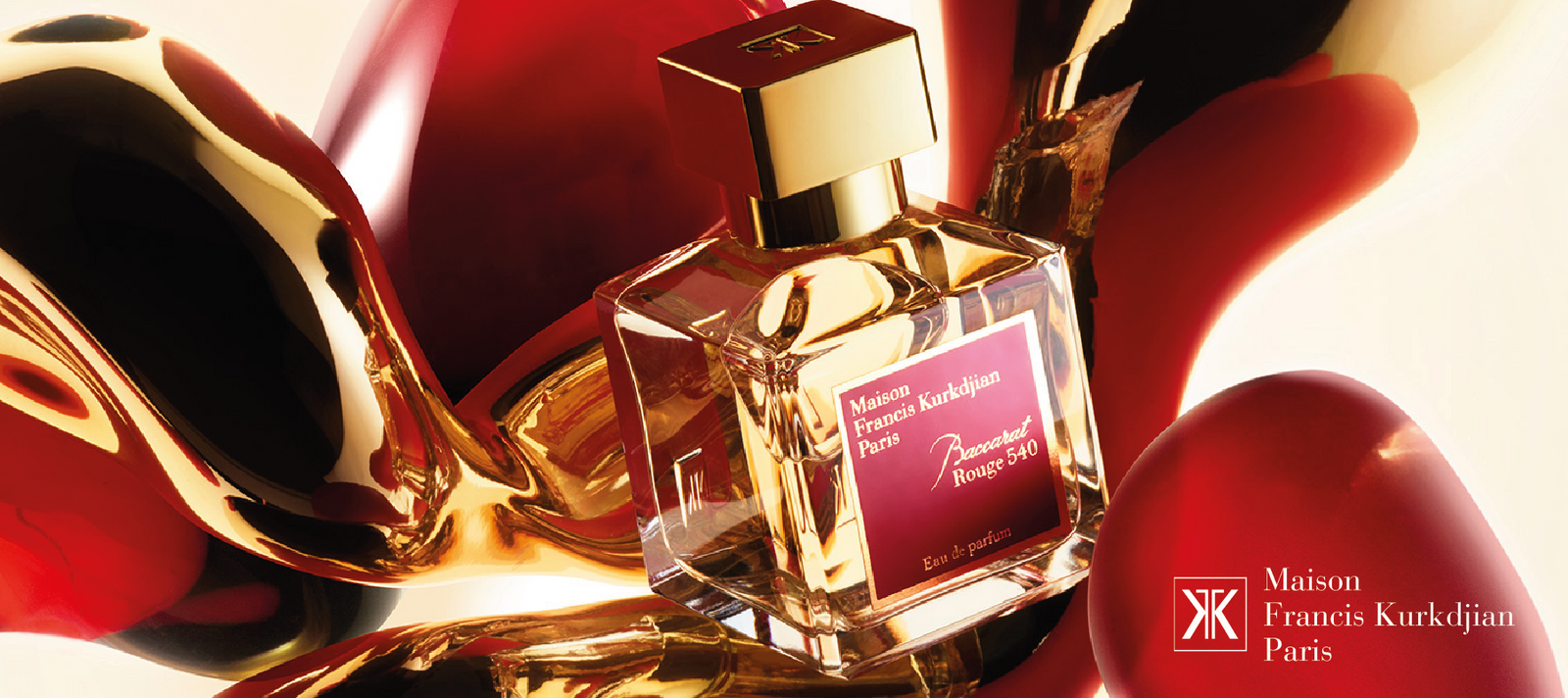 A bottle of Maison Francis Kurkdjian Baccarat Rouge 540 perfume is displayed against an abstract background of swirling red and gold shapes, with the brand’s logo on the bottom right.