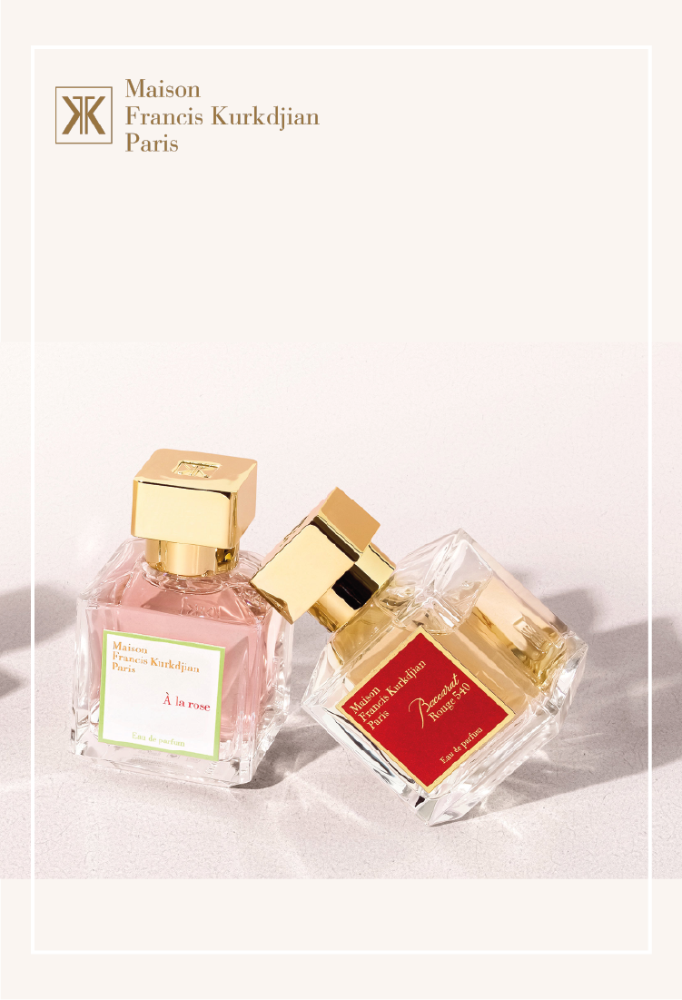 Two square Maison Francis Kurkdjian Paris perfume bottles with gold caps are shown, one with a pink label and liquid, the other with a red label and yellow liquid, displayed on a light surface. Brand name is visible at the top left.