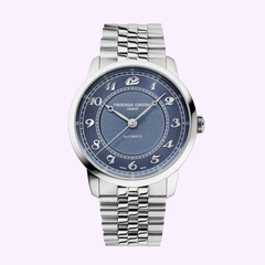 The Frederique Constant Watches Classics FC-301BL3B6B features a silver metal link band, blue dial with silver Arabic numerals and three hands, and “Frederique Constant” branding—showcasing Geneva watchmaking. Background: light purple.