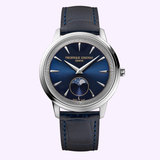 The Frederique Constant Watches Classics Moneta Moonphase FC-206N3S6 is a Swiss-made unisex luxury watch featuring a silver case, blue dial with silver hour markers, and a moonphase subdial. Complemented by a blue leather strap, this elegant timepiece from Frederique Constant is showcased against a light purple background, reflecting timeless sophistication.