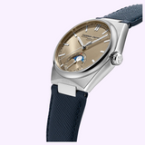 A silver Frederique Constant FC-716RG3NH6 Highlife Moonphase Date wristwatch with a textured bronze dial, featuring a moonphase indicator and a date sub-dial on a dark blue textured leather strap.