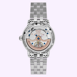 The silver-toned case back of a Frederique Constant FC-719NN3H6B Classic Worldtimer watch with a metal link bracelet, revealing the internal automatic movement, gears, and a rose-gold colored rotor.