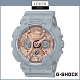The G-Shock GMAS120MF-8A S Series Analog Digital Women’s Watch features a grey resin strap and case with a rose gold face. Logos for LEXOR Miami and G-Shock Watches are displayed above and below this stylish accessory.