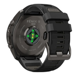 Back view of a Garmin Watches fēnix® 9 Pro – 51 mm 010-04337-15 smartwatch showing the glowing green heart rate sensor, titanium casing, and silicone watch band.