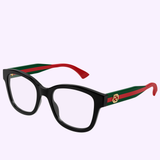 Gucci Optical Frames GG1863O-001 51 feature black thick frames, temples with green-red stripes and a gold circular logo, plus red curved tips. These Gucci Sunglasses exude luxury on a light purple background.