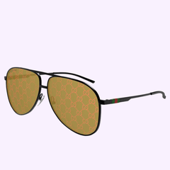 The Gucci Sunglass GG1677S-005 62 features black aviator frames, gold-tinted lenses, a repeating GG logo, and green-red-green stripes on the arms—a sleek choice for luxury fashion and modern style lovers.